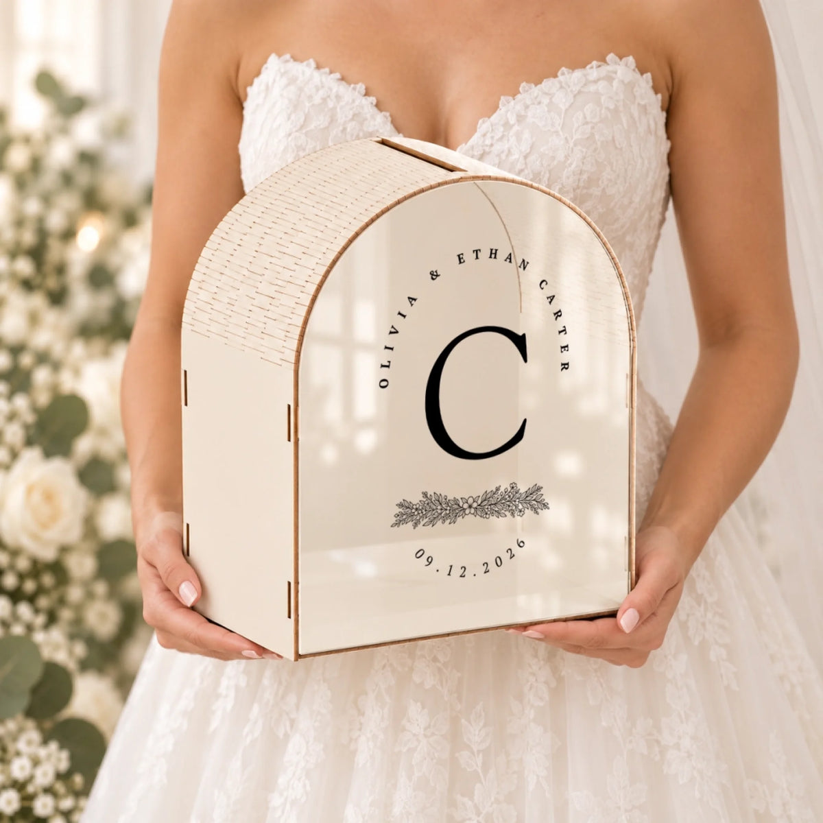 Personalized ivory wedding card box with custom botanical monogram held in hand