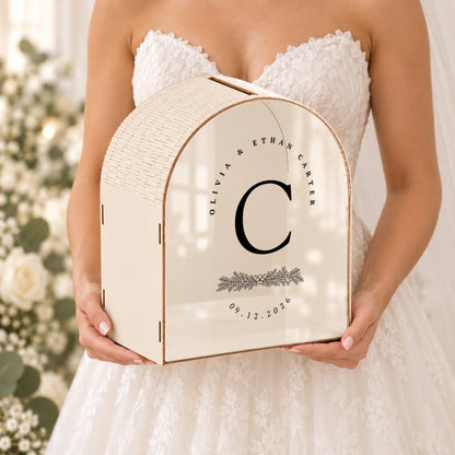 Personalized ivory wedding card box with custom botanical monogram held in hand